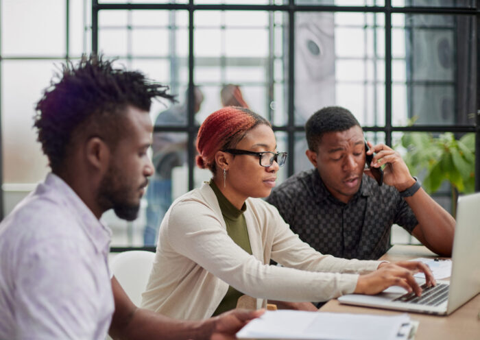 Young, motivated and experienced employees are brainstorming in the conference room.